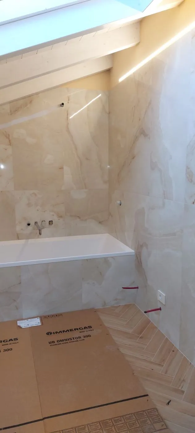 Bagno con rivestimento effetto onice e vasca